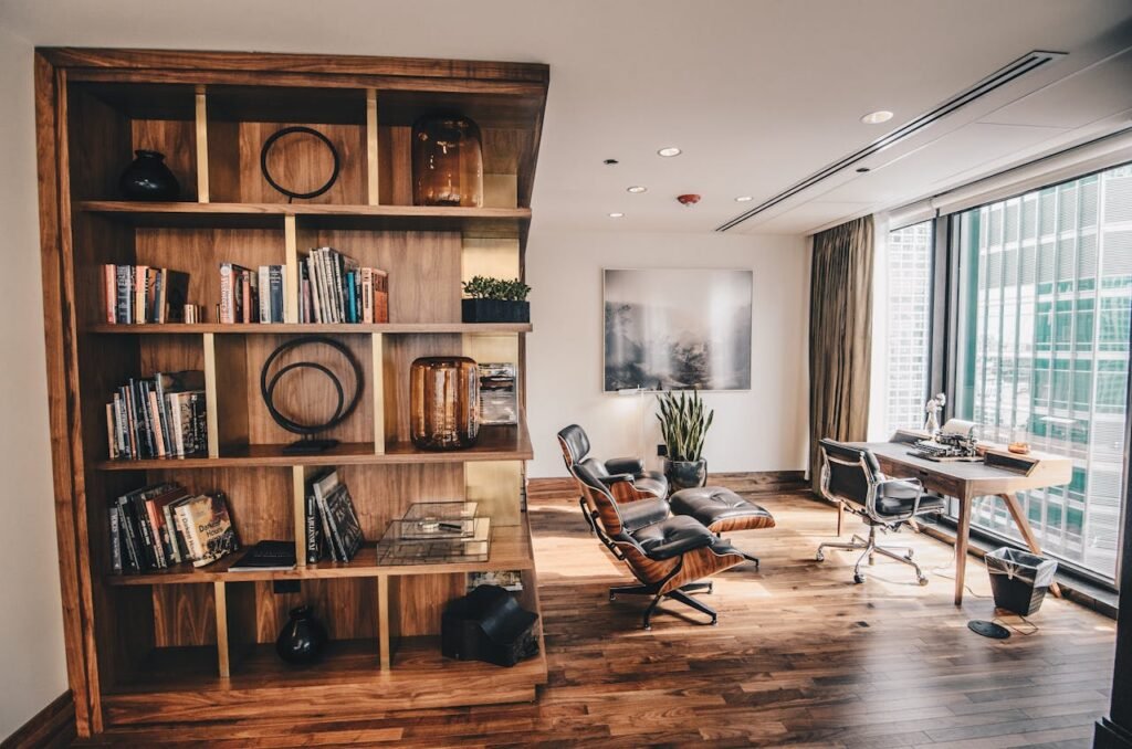 pexels photo 2883049 Stylish office space featuring a wooden bookshelf and a minimalist desk setup, ideal for work.